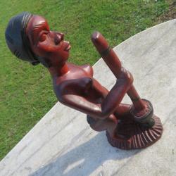 Sculpture Africaine en bois sculpt&eacute; &agrave; la main repr&eacute;sentant une grande femme au pilon (XX&eacute;)