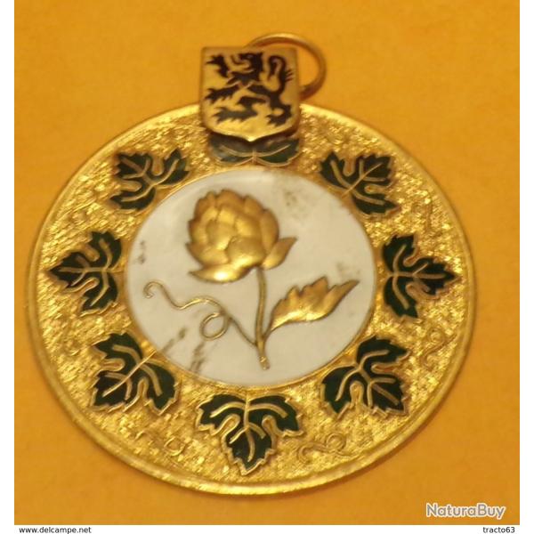 PLAQUE DE VEHICULE LION ET FLEUR , DIAMETRE 6 CM POIDS 60 GRAMMES , OCCASION, ETAT VOIR PHOTO . POUR